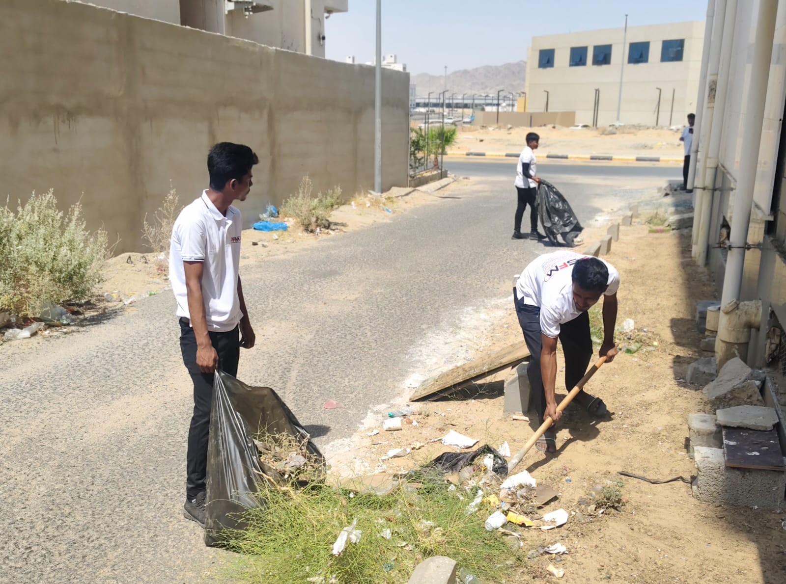 PSFM outdoor cleaning team collecting waste in Makkah